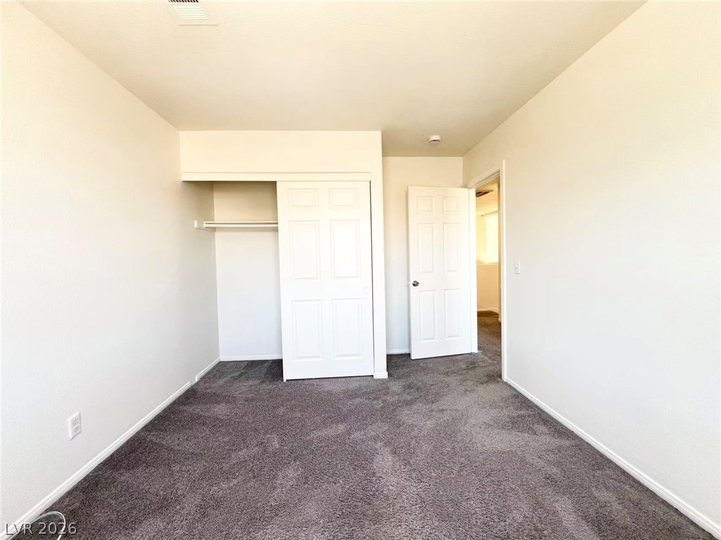 8284 West Rochelle Avenue Las Vegas, NV 89147 - Photo 23 of 29 A spacious room offers ample storage with a double-door closet and plush carpeting underfoot.