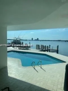 a room with stainless steel appliances granite countertop a sink and a stove