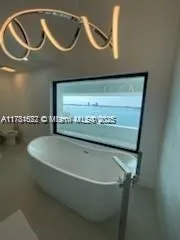 a bathroom with a glass shower door