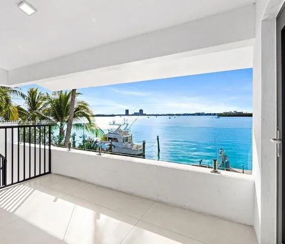 a kitchen with stainless steel appliances kitchen island granite countertop a stove a sink and a refrigerator