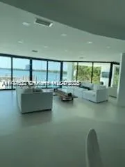 a kitchen with sink and view of living room
