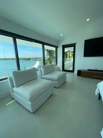 a living room with furniture and large window