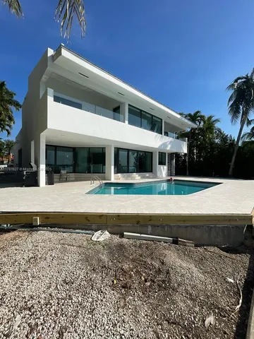 a view of a swimming pool and an outdoor seating