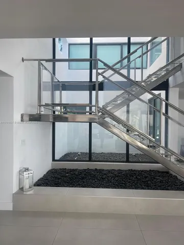 a view of a kitchen counter top space and staircase