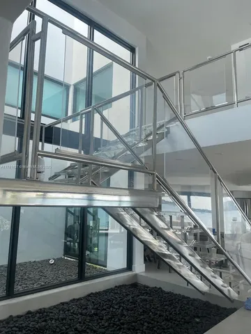 a view of an empty room with a floor to ceiling window and a flat screen tv