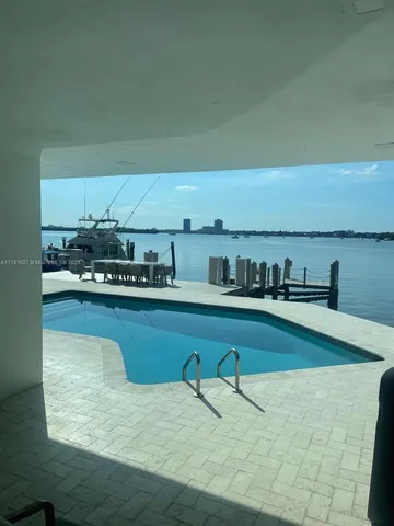 a living room with furniture and large windows