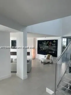 a kitchen view with white cabinets and refrigerator