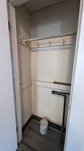 a view of storage and utility room with a refrigerator