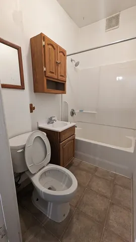 a bathroom with a toilet a sink and a mirror