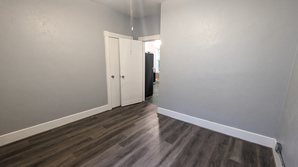 104 Rodney Street, Unit 2 Worcester, MA 01605 - Photo 6 of 7 a view of an empty room with wooden floor