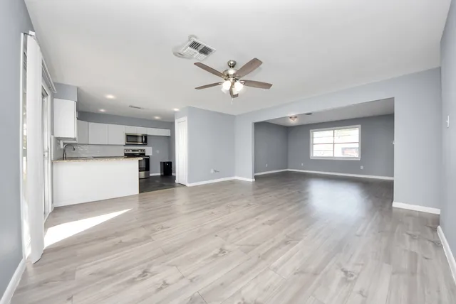 a view of a kitchen with wooden floor and a kitchen