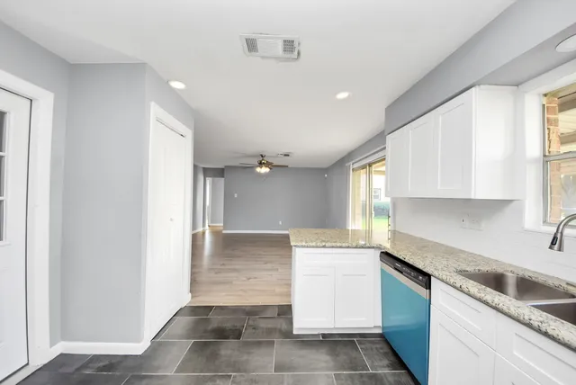 a kitchen with a sink a stove and cabinets
