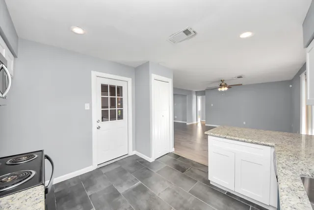 a view of a kitchen with a sink dishwasher and a microwave oven