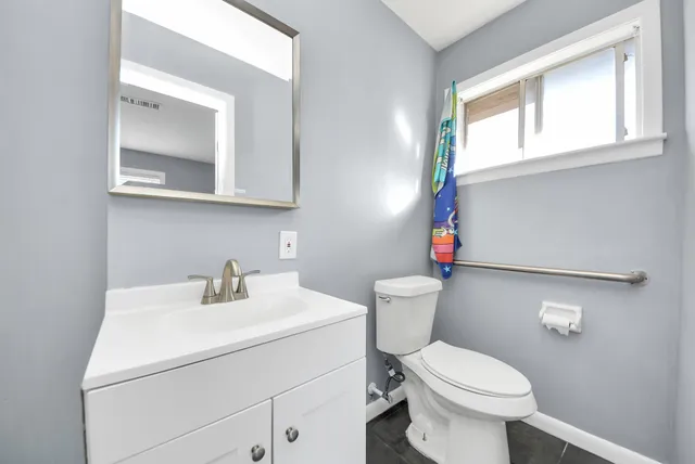 a bathroom with a sink toilet and a mirror