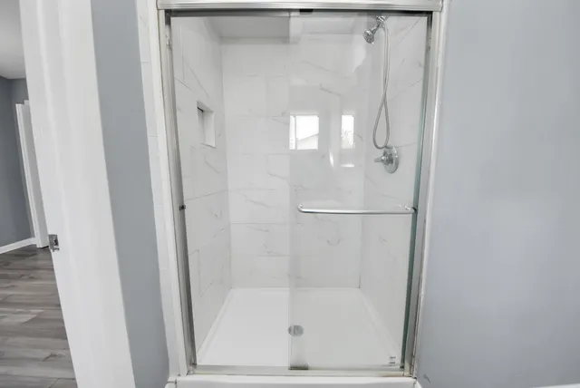 a bathroom with a glass shower door