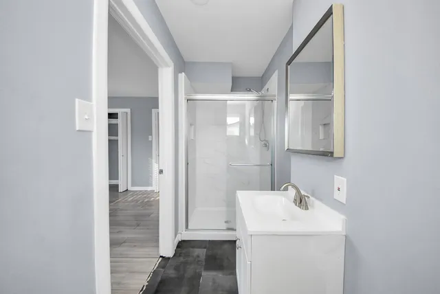 a bathroom with a sink a toilet and shower