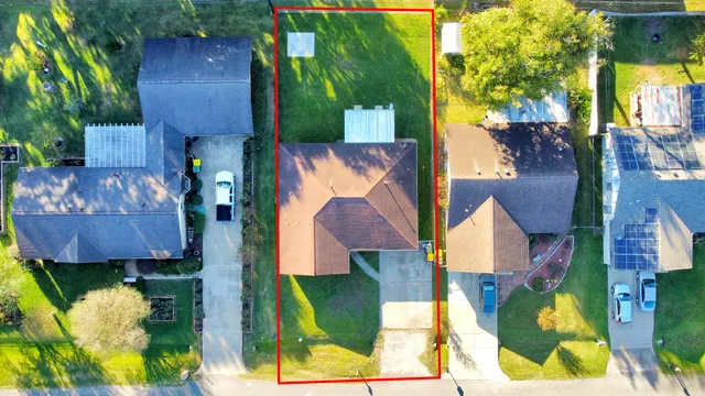 an aerial view of a house with a yard and garden