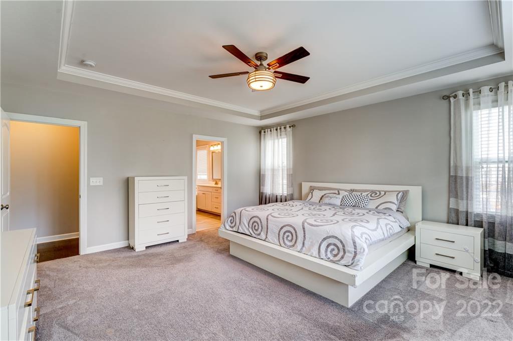 5409 Meadowcroft Way Fort Mill, SC 29708 - Photo 19 of 34 a bedroom with a bed and a ceiling fan