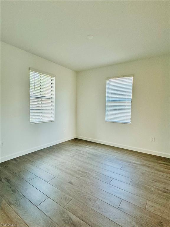20464 Verawood Loop Estero, FL 33928 - Photo 5 of 41 an empty room with wooden floor and windows
