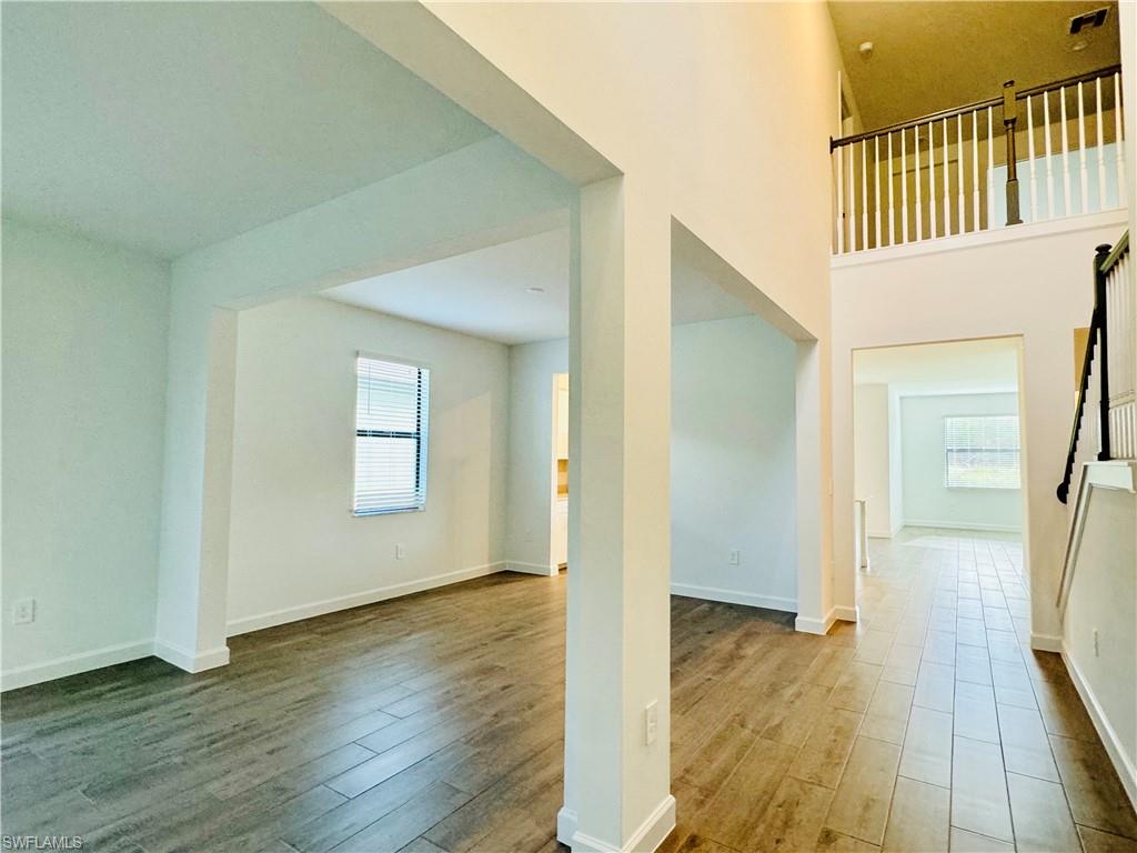 20464 Verawood Loop Estero, FL 33928 - Photo 7 of 41 a view of a hallway view with wooden floor and staircase