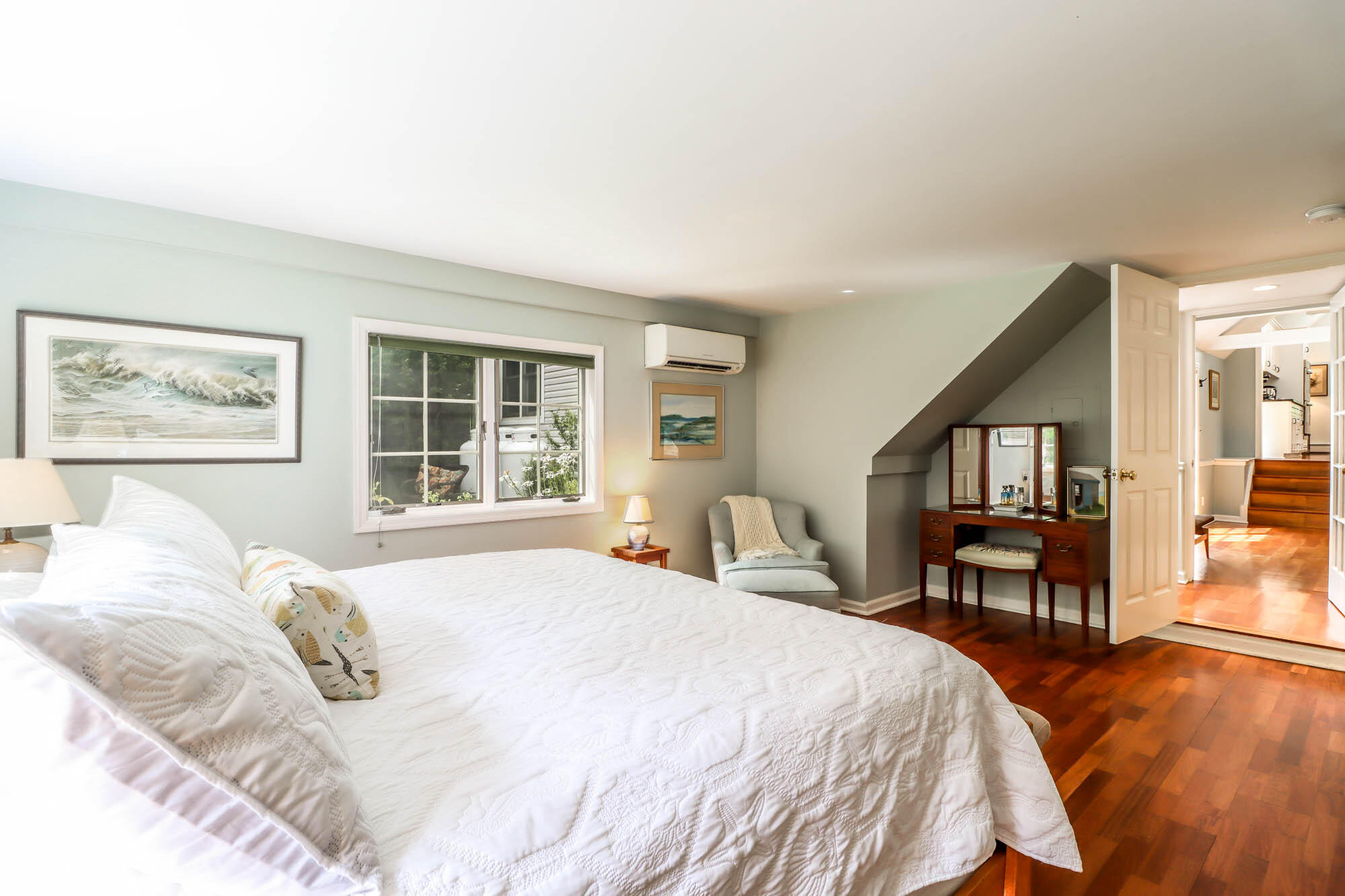 262 White Oak Shade Road New Canaan, CT 06840 - Photo 11 of 37 a bedroom with a large bed and a window with chair