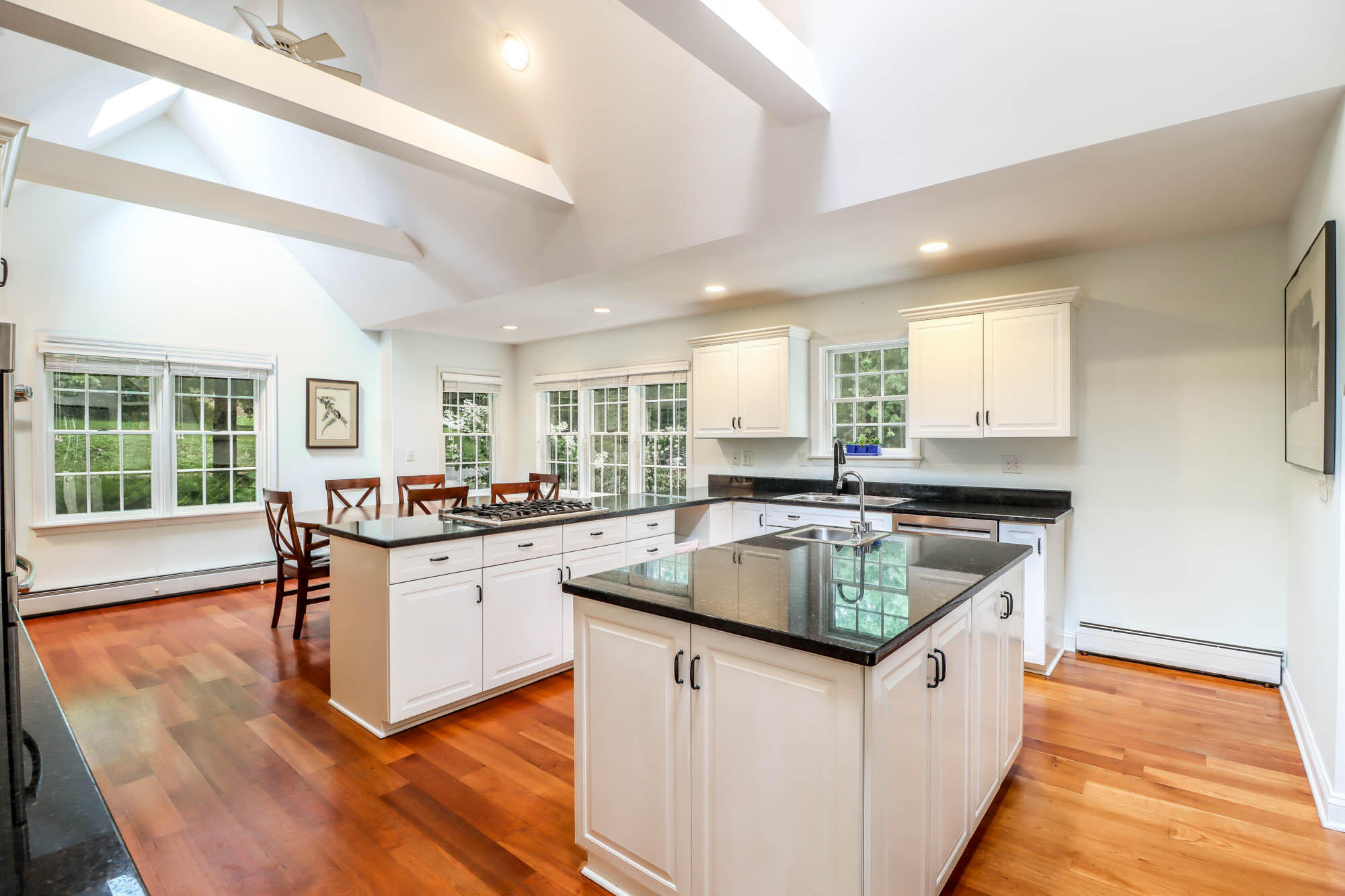 262 White Oak Shade Road New Canaan, CT 06840 - Photo 15 of 37 a kitchen with granite countertop kitchen island sink stove and white cabinets
