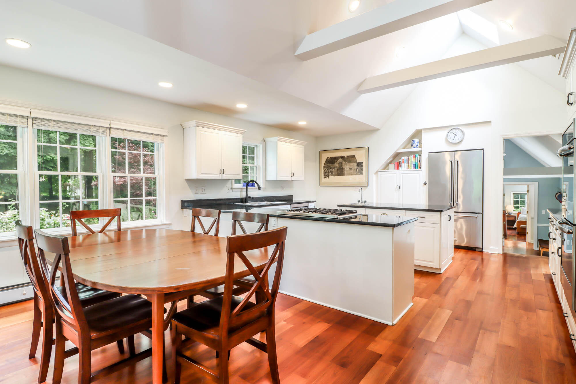 262 White Oak Shade Road New Canaan, CT 06840 - Photo 18 of 37 a kitchen with stainless steel appliances granite countertop a stove a refrigerator a kitchen island and chairs with wooden floor