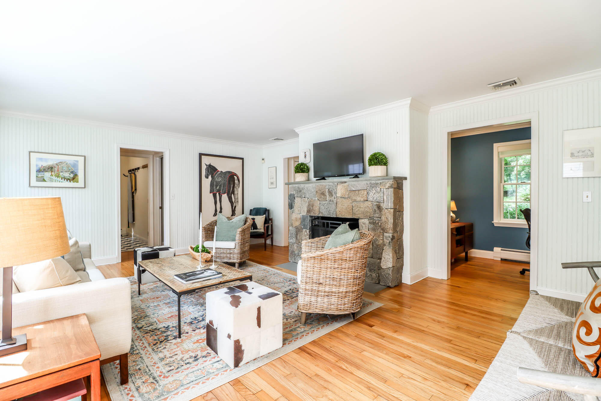 262 White Oak Shade Road New Canaan, CT 06840 - Photo 21 of 37 a living room with furniture a flat screen tv and a fireplace