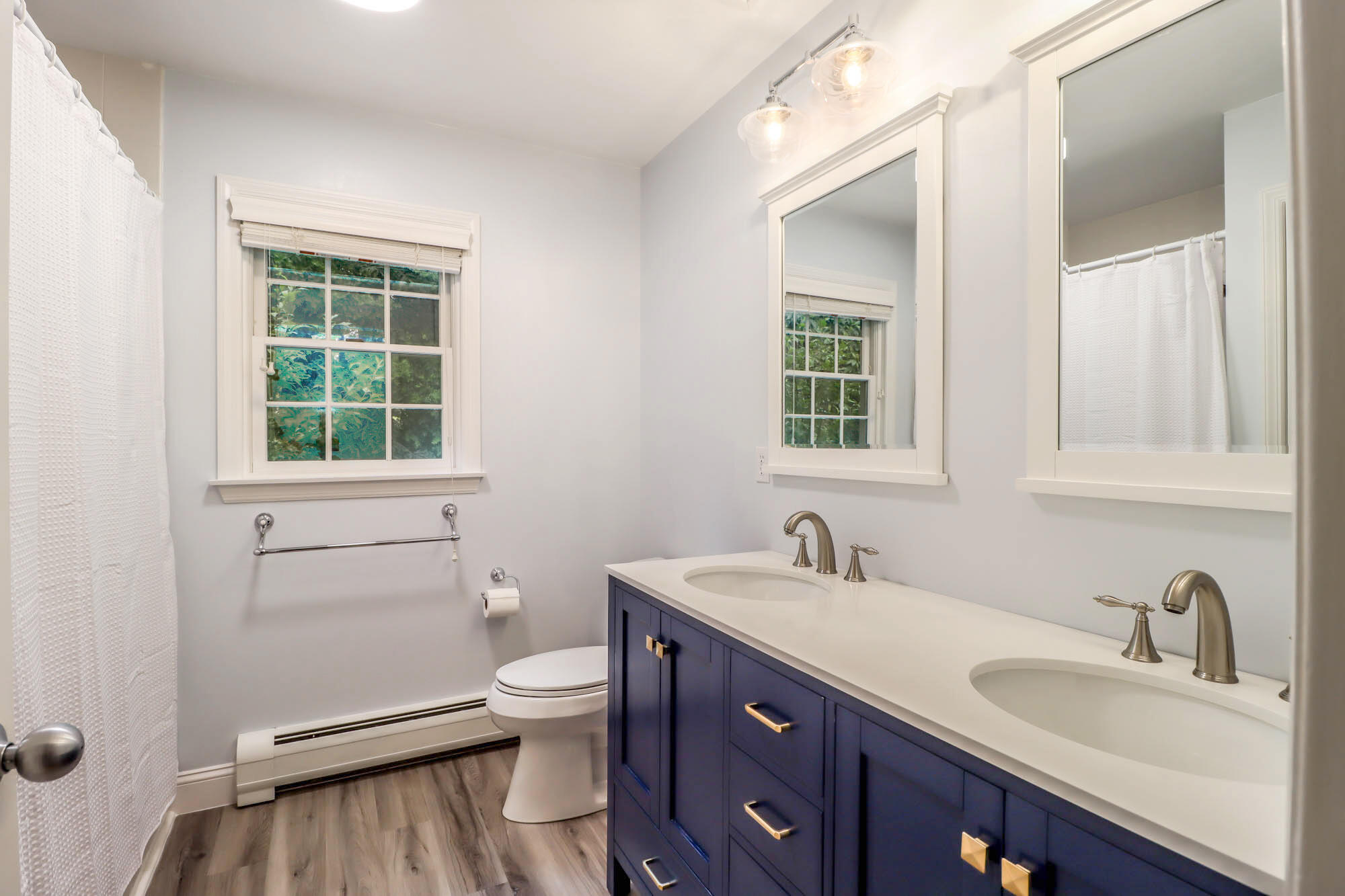262 White Oak Shade Road New Canaan, CT 06840 - Photo 25 of 37 a bathroom with a granite countertop toilet a sink a mirror and a window