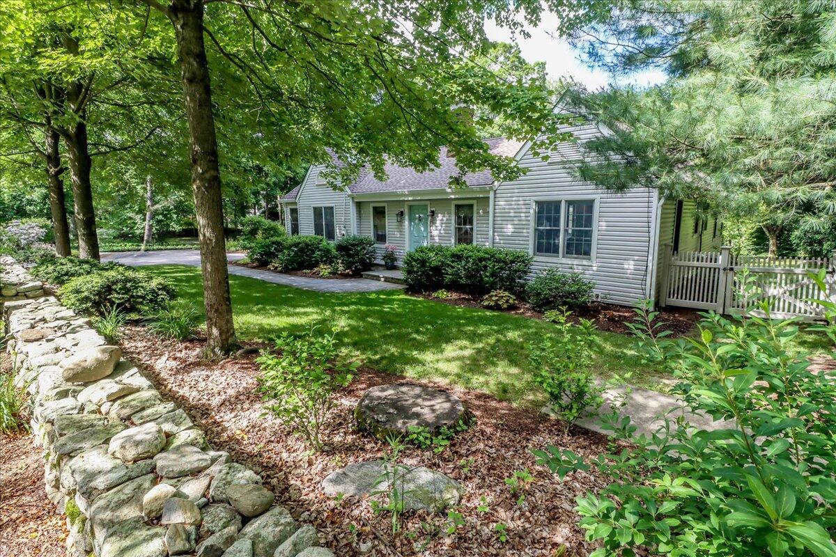 262 White Oak Shade Road New Canaan, CT 06840 - Photo 3 of 37 a front view of a house with garden