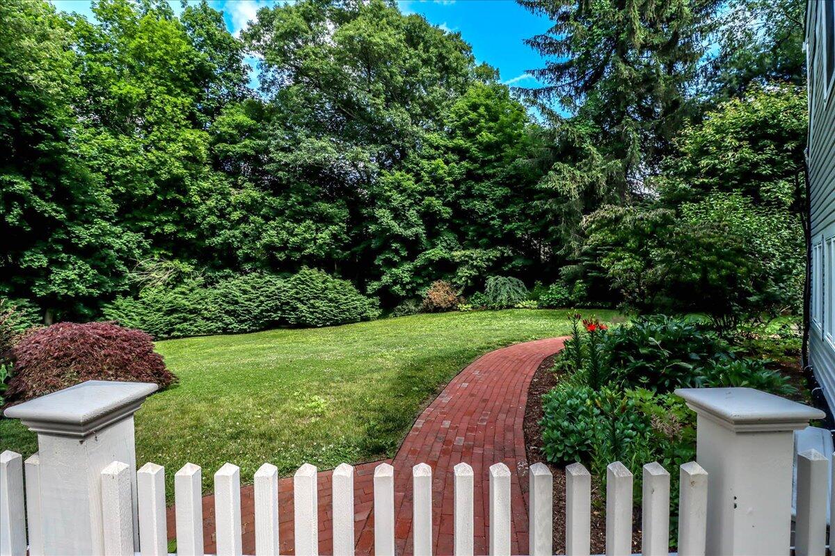 262 White Oak Shade Road New Canaan, CT 06840 - Photo 31 of 37 a view of a yard with plants and wooden fence