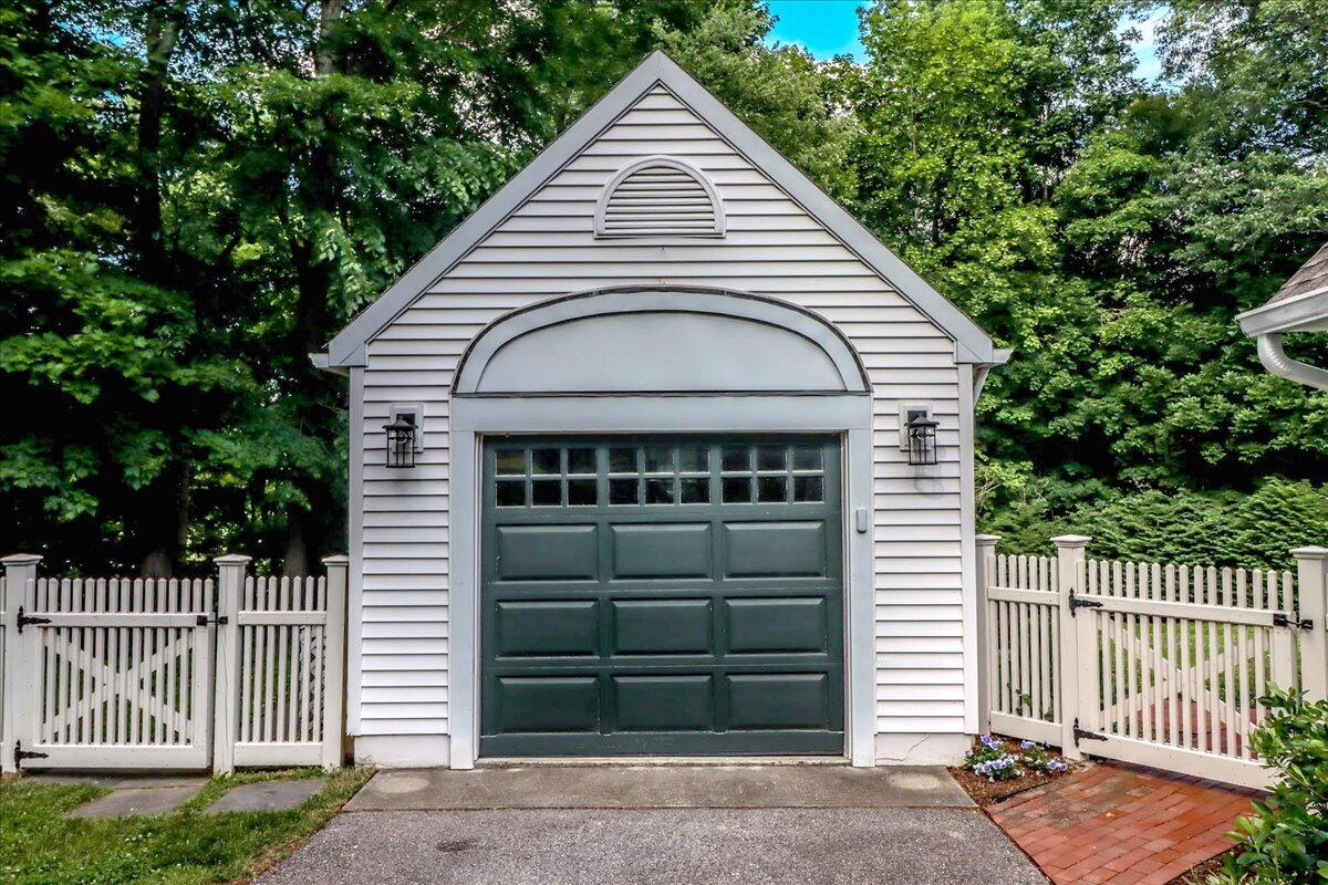 262 White Oak Shade Road New Canaan, CT 06840 - Photo 37 of 37 a view of a house with a small yard and wooden fence and large trees