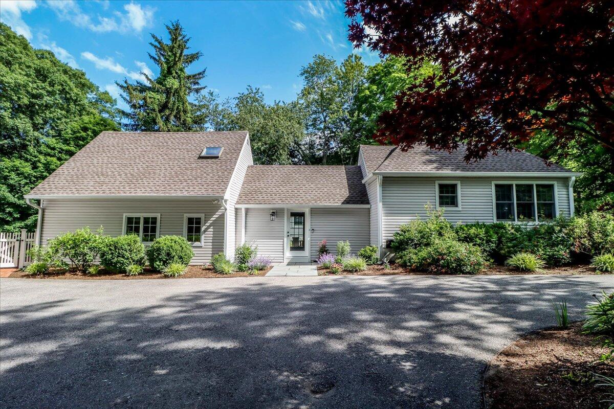 262 White Oak Shade Road New Canaan, CT 06840 - Photo 6 of 37 a front view of a house with a yard