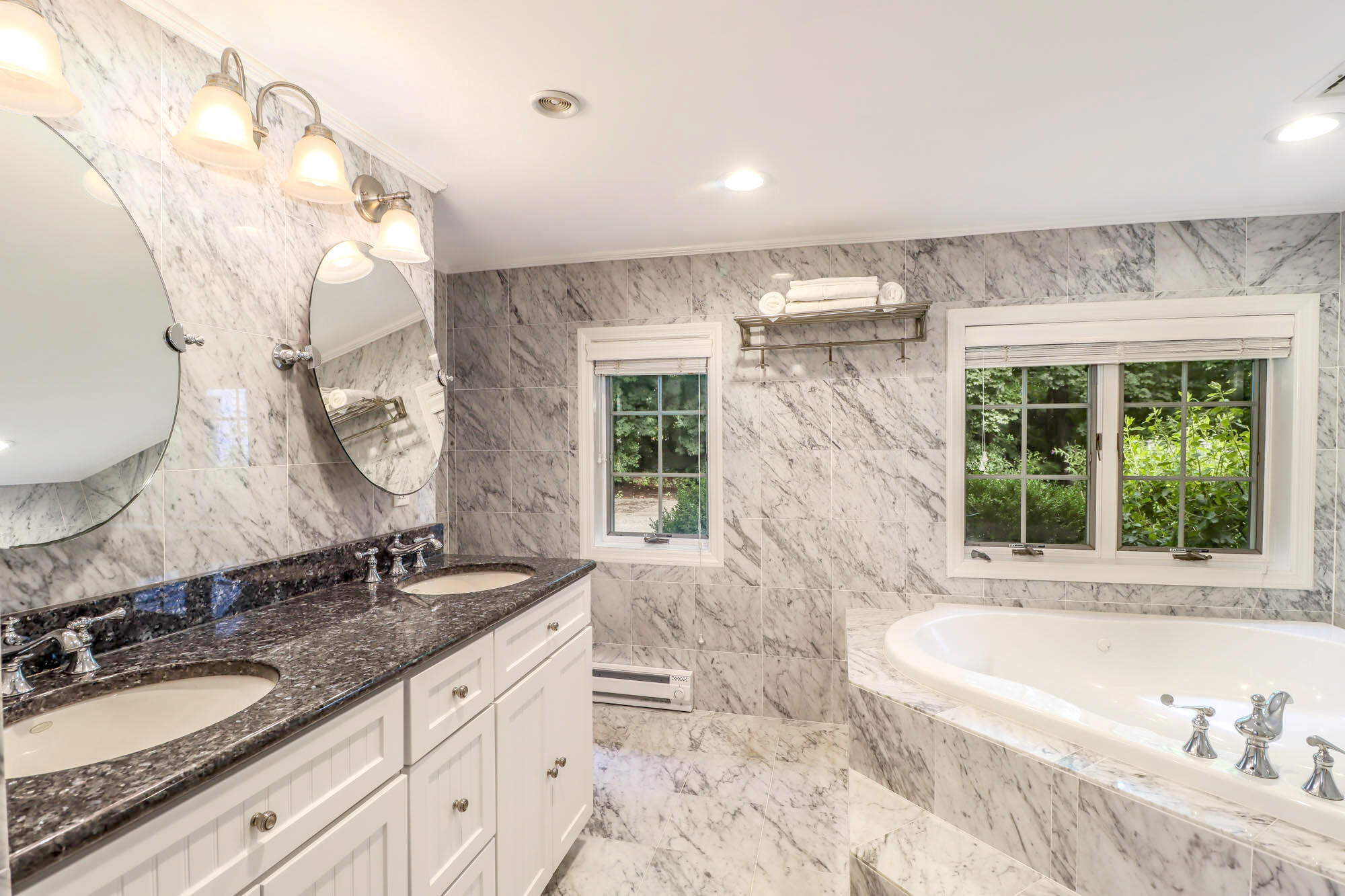 262 White Oak Shade Road New Canaan, CT 06840 - Photo 9 of 37 a bathroom with a granite countertop tub a sink and a large mirror
