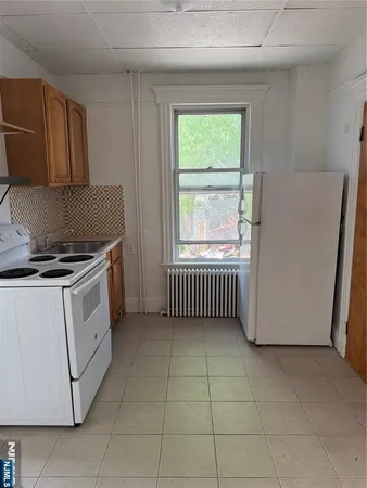 a kitchen with a stove a sink and a microwave