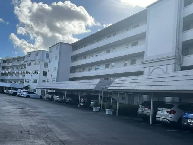 a kitchen with stainless steel appliances a refrigerator sink and microwave