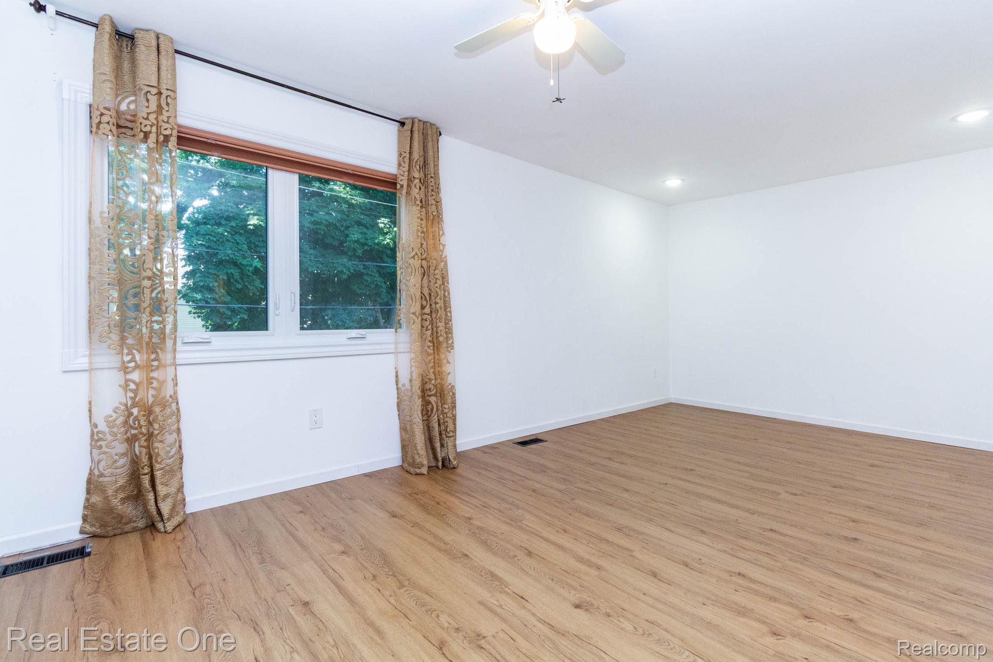 111 Manor Way Rochester, MI 48309 - Photo 17 of 36 Interior space featuring light wood-finish flooring, white walls, and a ceiling fan