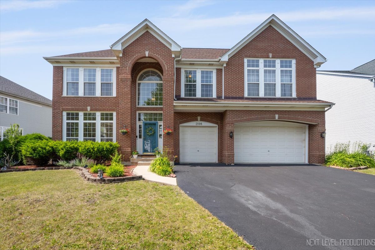 2198 Kemmerer Lane Bolingbrook, IL 60490 - Photo 1 of 1 a front view of a house with yard and green space