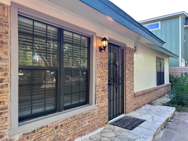 a view of a kitchen with a sink and a window