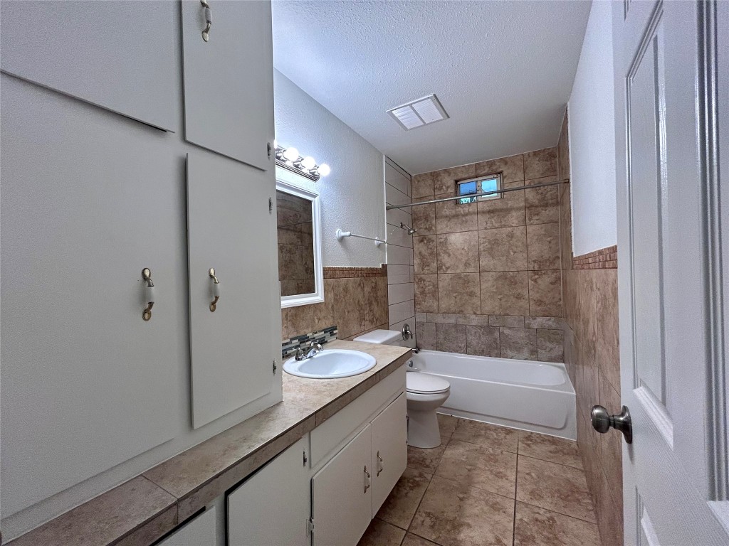 6200 Palm Circle Austin, TX 78741 - Photo 8 of 18 a bathroom with a granite countertop sink a toilet and shower