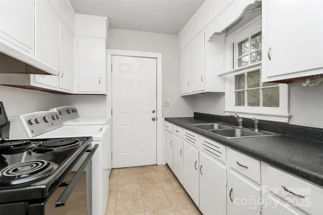 a kitchen with stainless steel appliances granite countertop a sink stove and cabinets