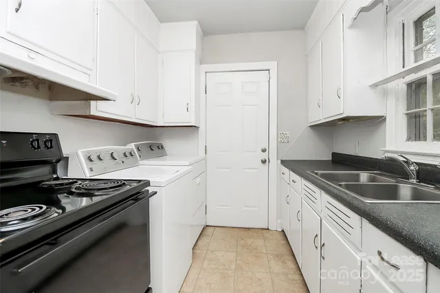 a kitchen with granite countertop a sink stove and cabinets