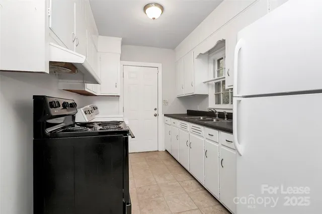 a kitchen with stainless steel appliances granite countertop a refrigerator and a stove