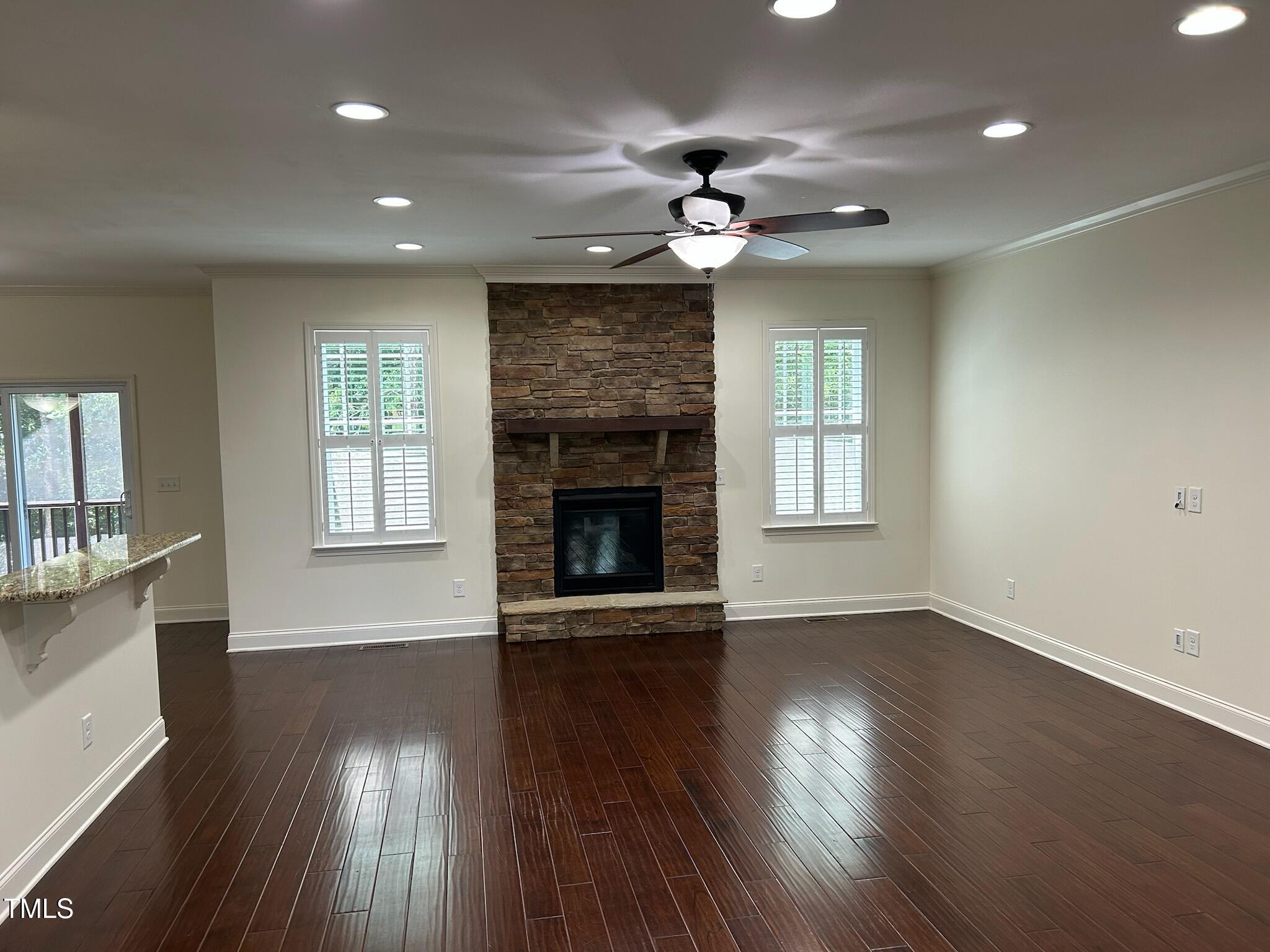 337 Shadowdale Lane Rolesville, NC 27571 - Photo 13 of 74 an empty room with wooden floor fireplace and windows