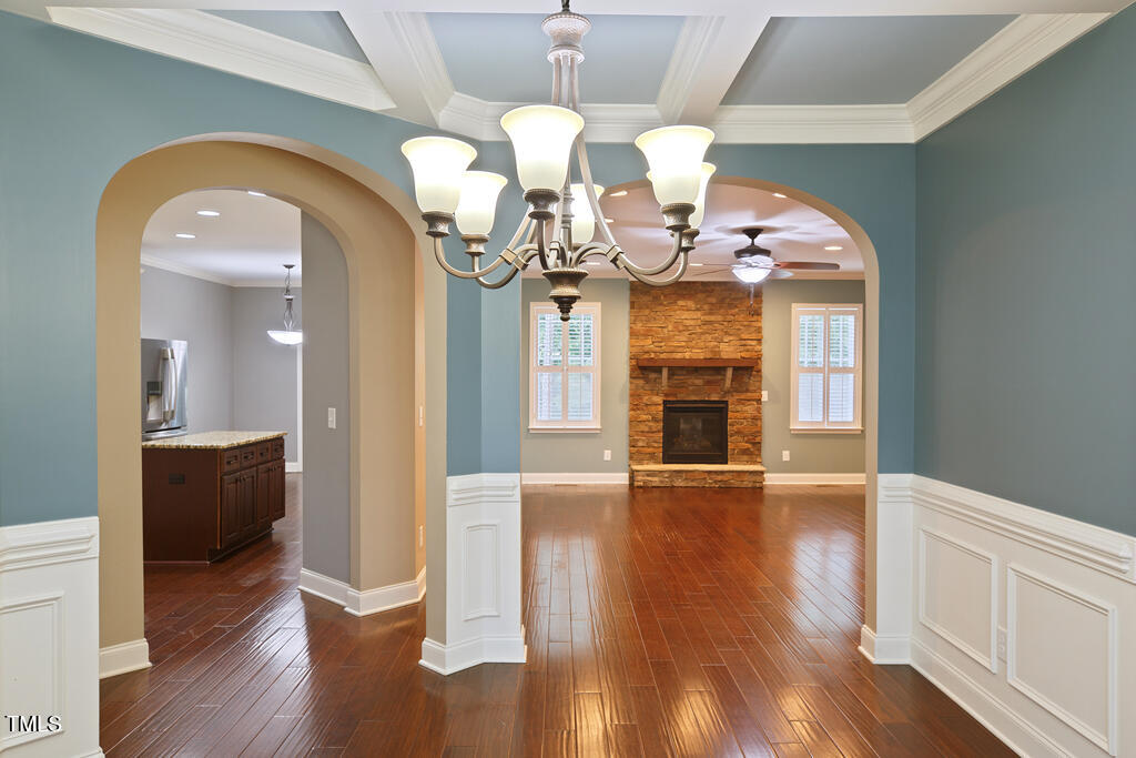 337 Shadowdale Lane Rolesville, NC 27571 - Photo 16 of 74 a view of a livingroom with a fireplace a chandelier and wooden floor