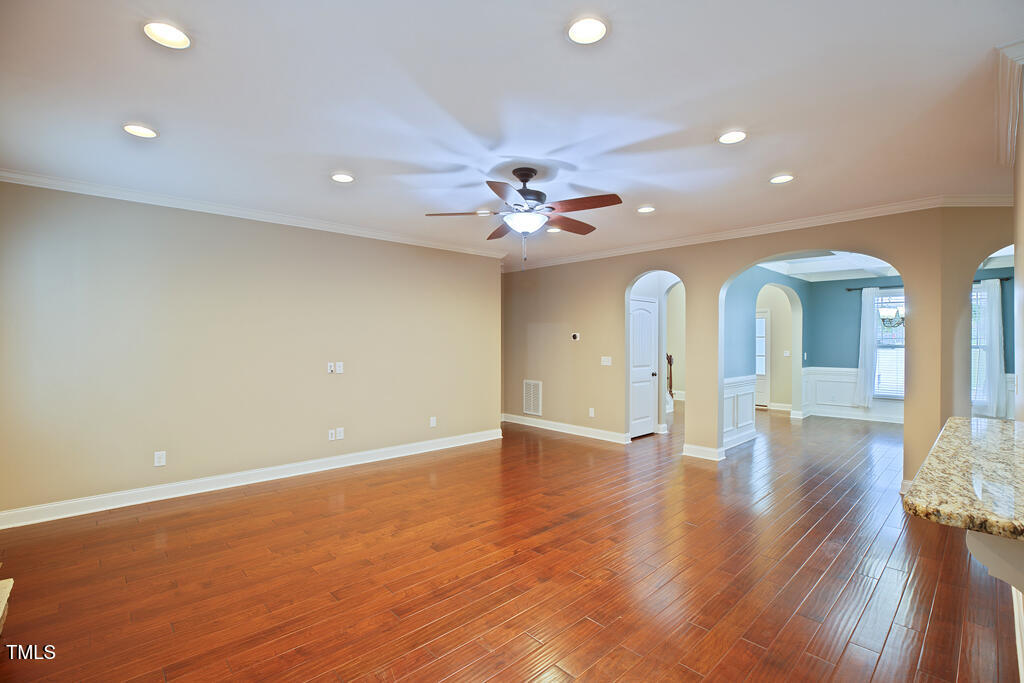 337 Shadowdale Lane Rolesville, NC 27571 - Photo 17 of 74 a view of an empty room with wooden floor and a ceiling fan