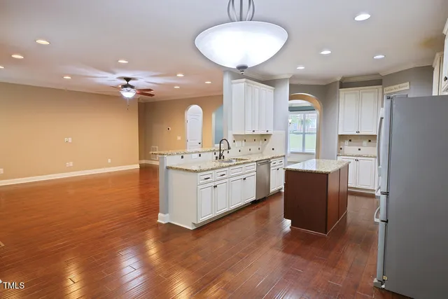 a spacious bathroom with a granite countertop sink and a mirror