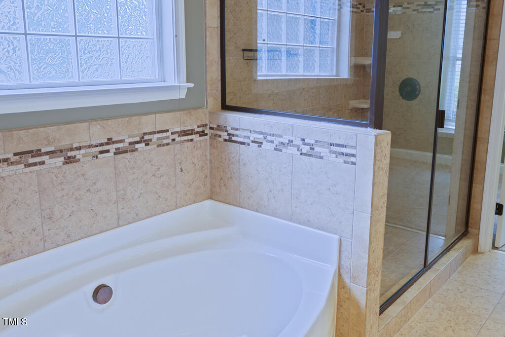 337 Shadowdale Lane Rolesville, NC 27571 - Photo 22 of 74 a bathroom with a bathtub and a shower