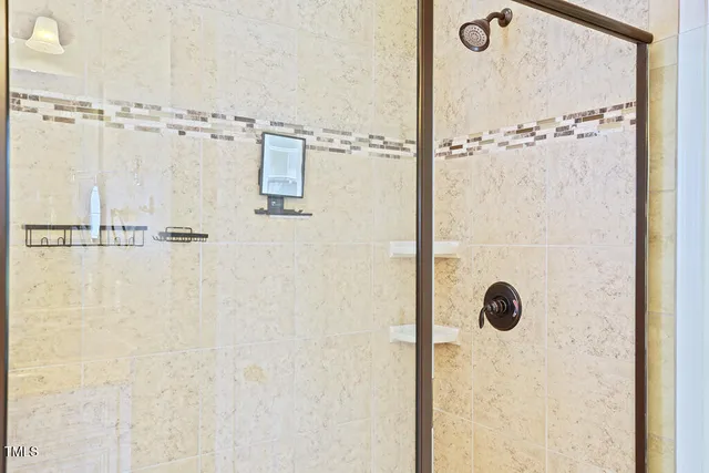 en empty room with a ceiling fan and a chandelier fan