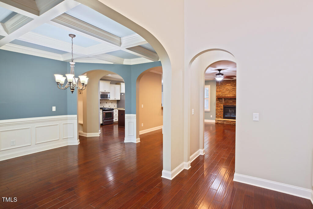 337 Shadowdale Lane Rolesville, NC 27571 - Photo 9 of 74 a view of a hallway with wooden floor and a chandelier